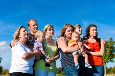 Family and multi-generation - fun on meadow in summer
