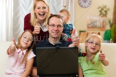 Family in front of computer having video conference