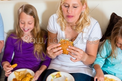 Family is eating hamburger or fast food