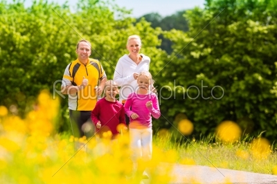 Family jogging for sport outdoors