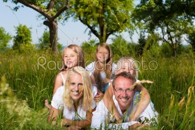 Family lying in the meadow