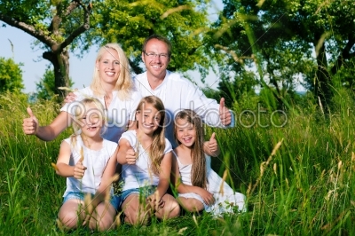 Family lying in the meadow