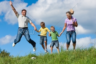 Family outdoors jumping