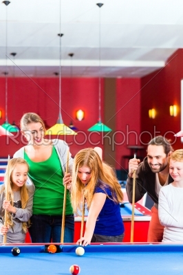 Family playing pool billiard game 