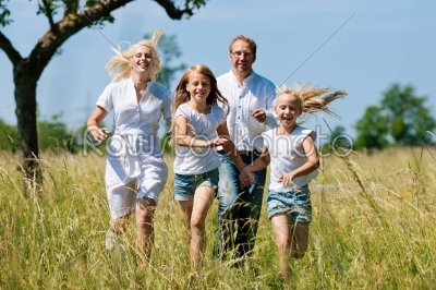 Family running in the meadow