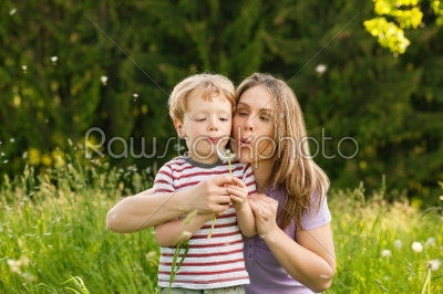 Family summer - blowing dandelion seeds