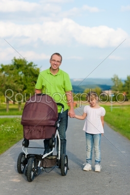 Father with child and baby buggy 