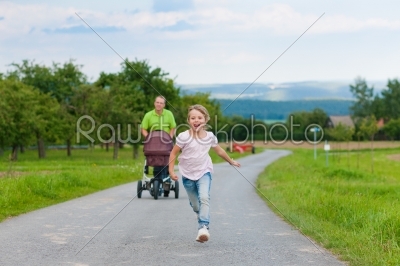 Father with child and baby buggy 
