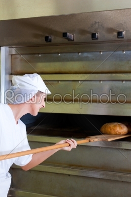 Female baker baking bread
