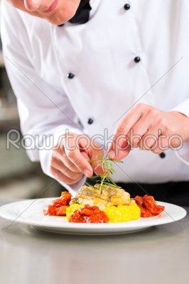 Female Chef in restaurant kitchen cooking