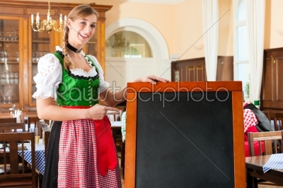 Female Innkeeper in traditional Bavarian clothes in pub