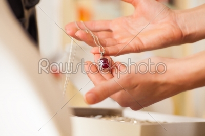 Female jeweller presenting jewellery