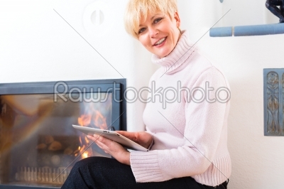 Female Senior at home in front of fireplace