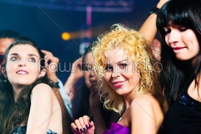 Friends dancing in club or disco