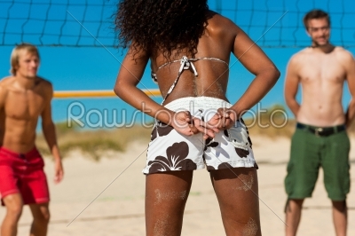 Friends playing beach volleyball