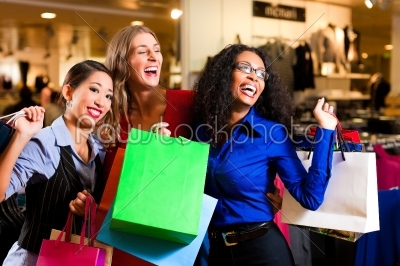 Friends shopping with bags in mall