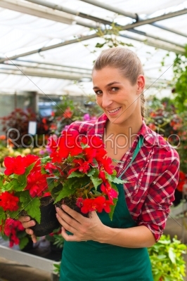 gardener in her green house flower shop