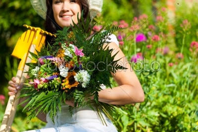 Gardening in summer - woman with flowers