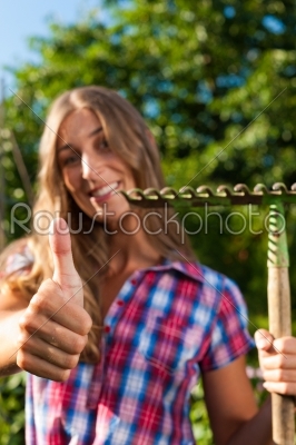 Gardening in summer - woman with grate