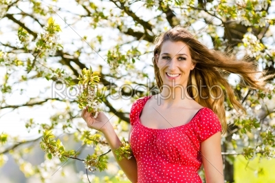 Girl in spring and tree blossom