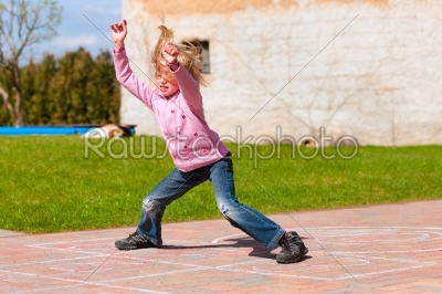 Girl playing in spring garden having fun