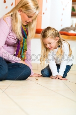 Girl playing with wooden toy spinner