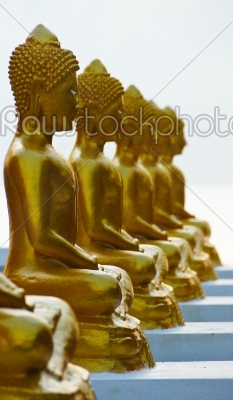 Gold Buddha on the beach in Ancient temple of Thailand