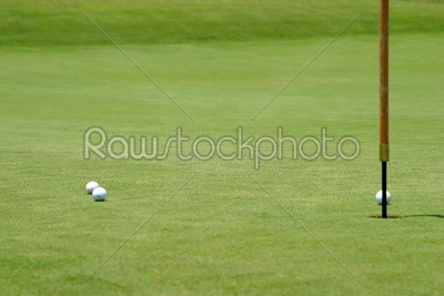 Golf balls near flagstick