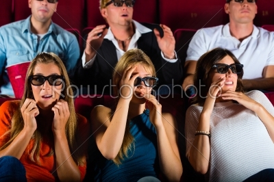 Group of people watching 3d movie at movie theater