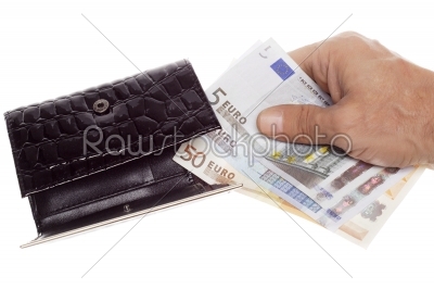 Hand holding a euro into wallet