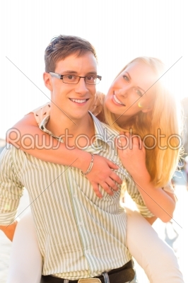 Happy couple - man carrying woman piggyback