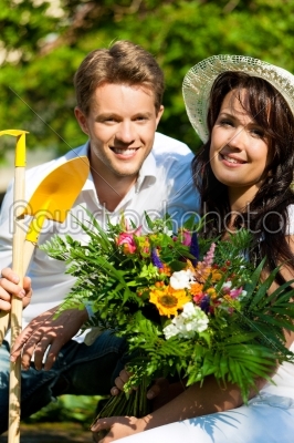 Happy couple gardening in summer