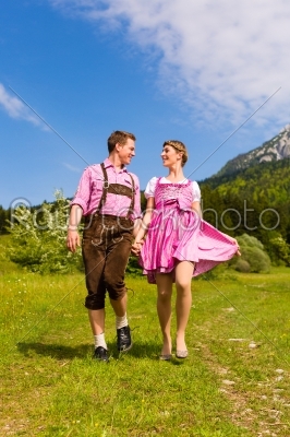 Happy couple hiking in Alpine meadow 