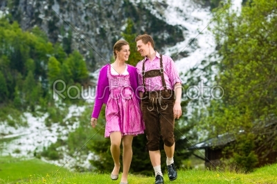 Happy couple hiking in Alpine meadow