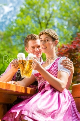 Happy Couple in Beer garden drinking beer