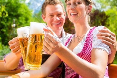 Happy Couple in Beer garden drinking beer