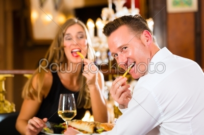 happy couple in restaurant eat fast food