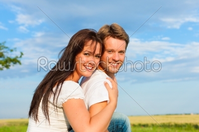 Happy couple on a meadow
