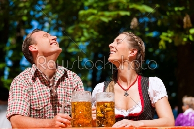 Happy Couple sitting in Beer garden 