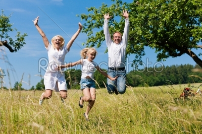 Happy family outdoors jumping
