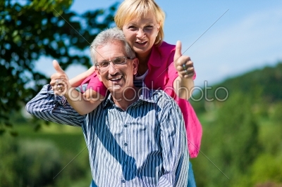happy mature or senior couple having walk