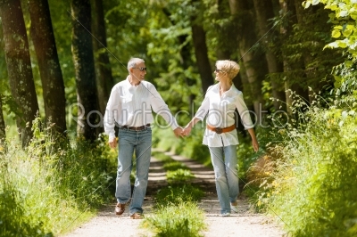 Happy senior couple outdoors running