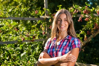Happy woman in her summer garden