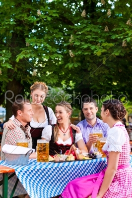 In Beer garden - friends on a table with beer