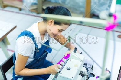 Indonesian seamstress in a textile factory