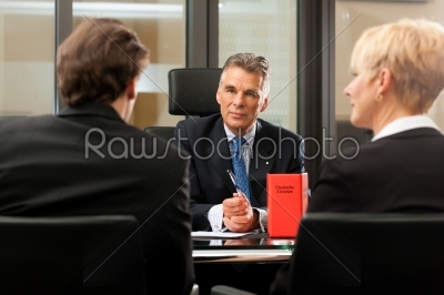 Lawyer or notary with clients in his office