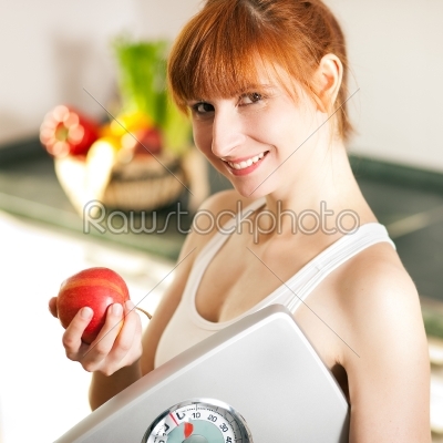 loosing weight - woman with scale and apple
