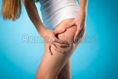 Loosing weight - young woman checking her leg