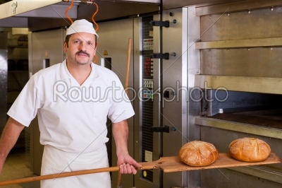 Male baker baking bread
