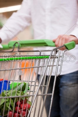 Male Shopper with Trolley at Supermarket